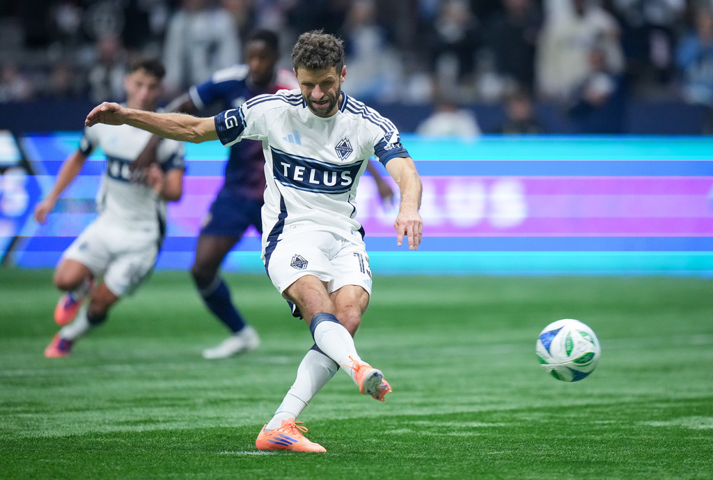 Vancouver Whitecaps' Thomas Muller scores on a penalty kick during the second half in Game 1 against FC Dallas in the first round of MLS soccer's Western Conference playoffs in Vancouver, British Columbia, Sunday, Oct. 26, 2025. (Darryl Dyck/The Canadian Press via AP)