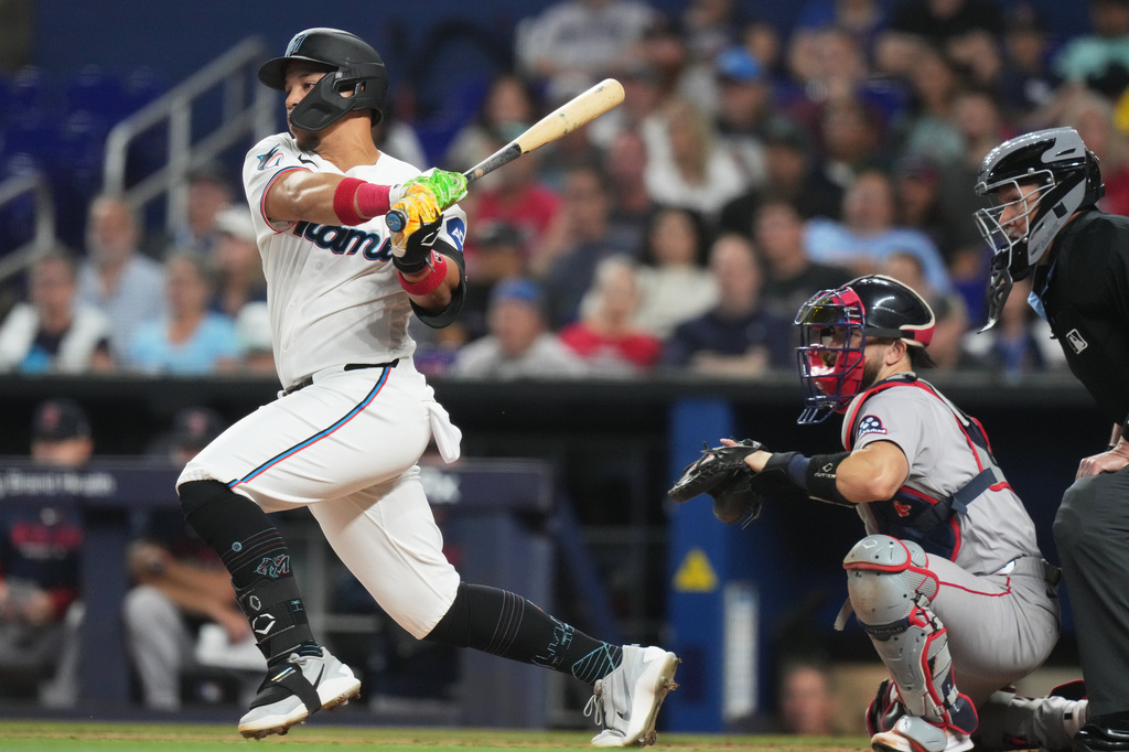 Miami Marlins' Heriberto Hernández hits a RBI single to score Kyle Stowers during the first inning of a baseball game, against the Boston Red Sox, Wednesday, Aug. 26, 2026, in Miami. (AP Photo/Lynne Sladky)