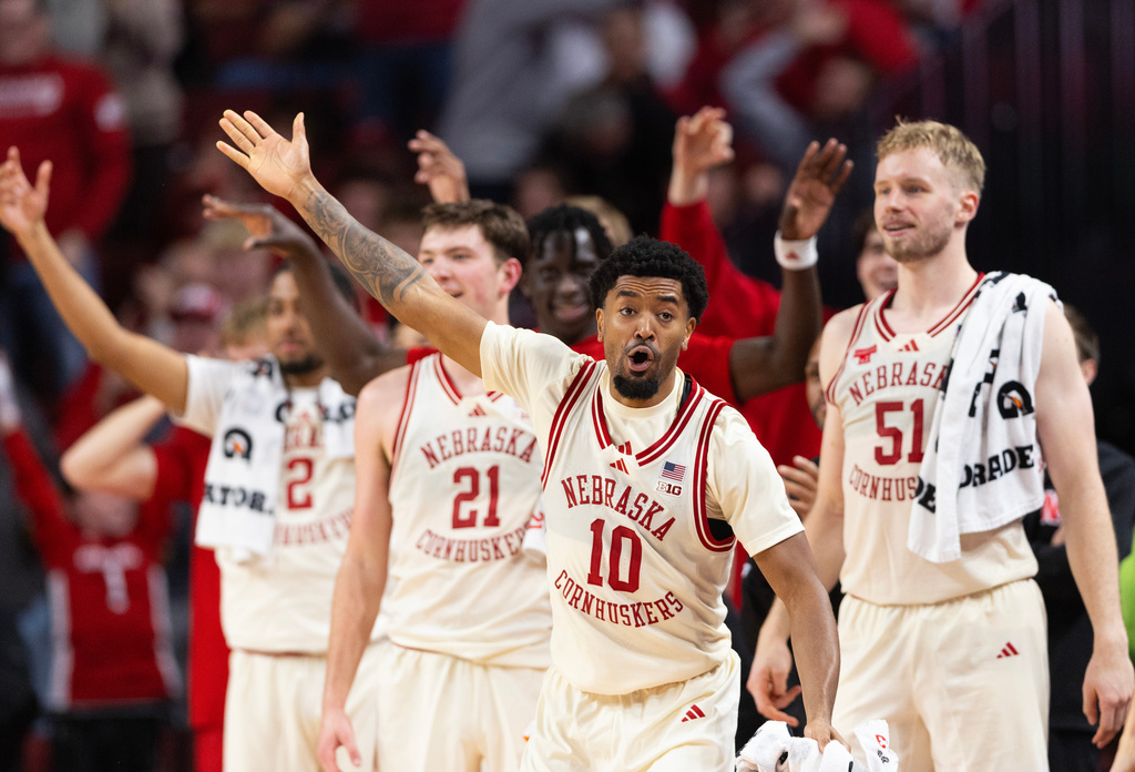 Nebraska's Jamarques Lawrence (10) and the Nebraska bench celebrate after Berke Büyüktuncel made a three-point shot during the second half of an NCAA college basketball game, Wednesday, Dec. 10, 2025, in Lincoln, Neb. (AP Photo/Rebecca S. Gratz)