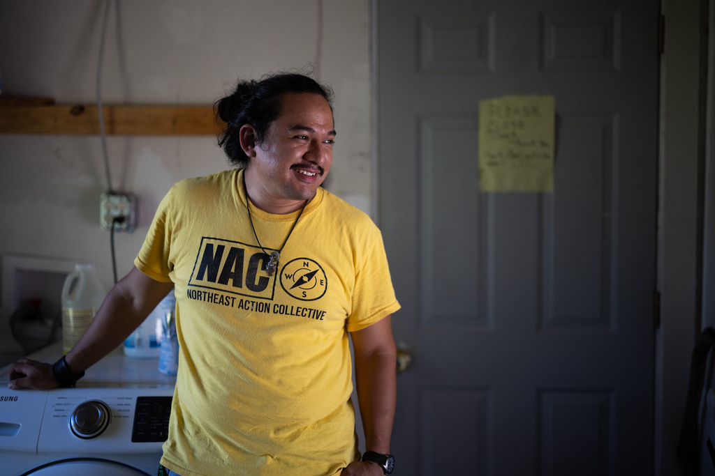David Espinoza, Hub home captain and co-director of community organizing at West Street Recovery, smiles inside of fellow hub home captain Doris Brown's home, Wednesday, Oct. 8, 2025, in Houston. (AP Photo/Antranik Tavitian)
