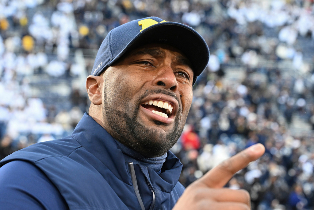 FILE - Michigan acting head coach Sherrone Moore celebrates a 24-15 win over Penn State following an NCAA college football game, Saturday, Nov. 11, 2023, in State College, Pa. (AP Photo/Barry Reeger, File)