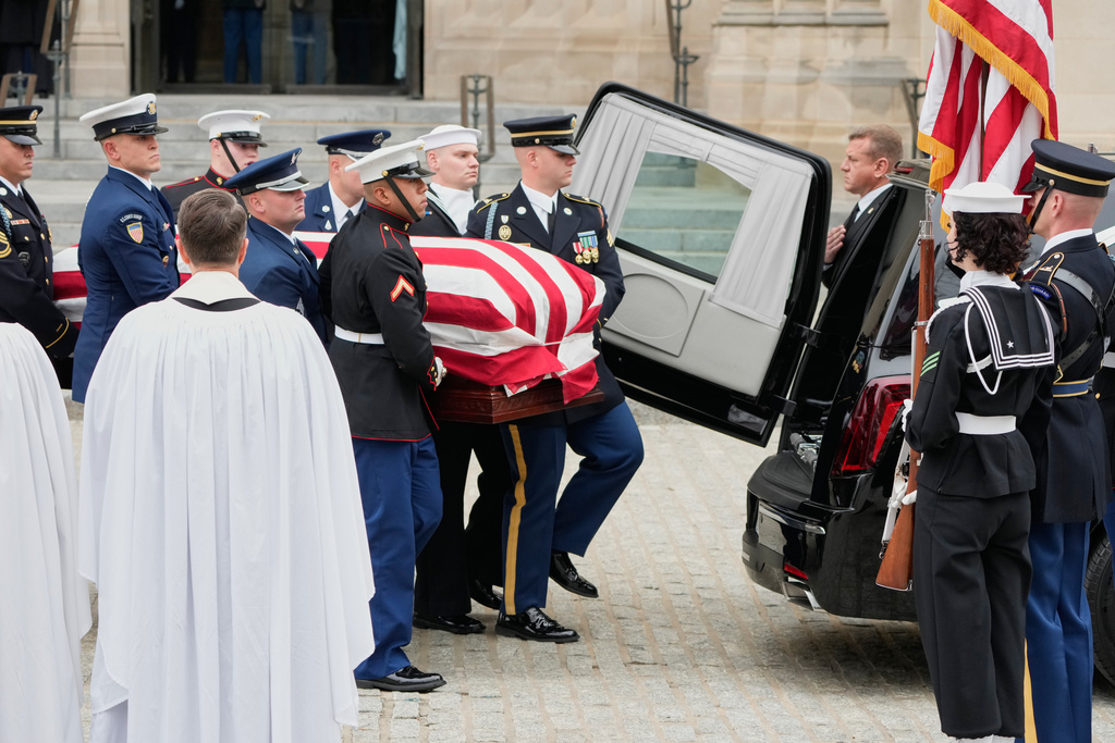 A joint services body bearer team carries the flag-draped casket of former Vice President Dick Cheney out of the Washington National Cathedral, Thursday, Nov. 20, 2025, in Washington. (AP Photo/Mark Schiefelbein)