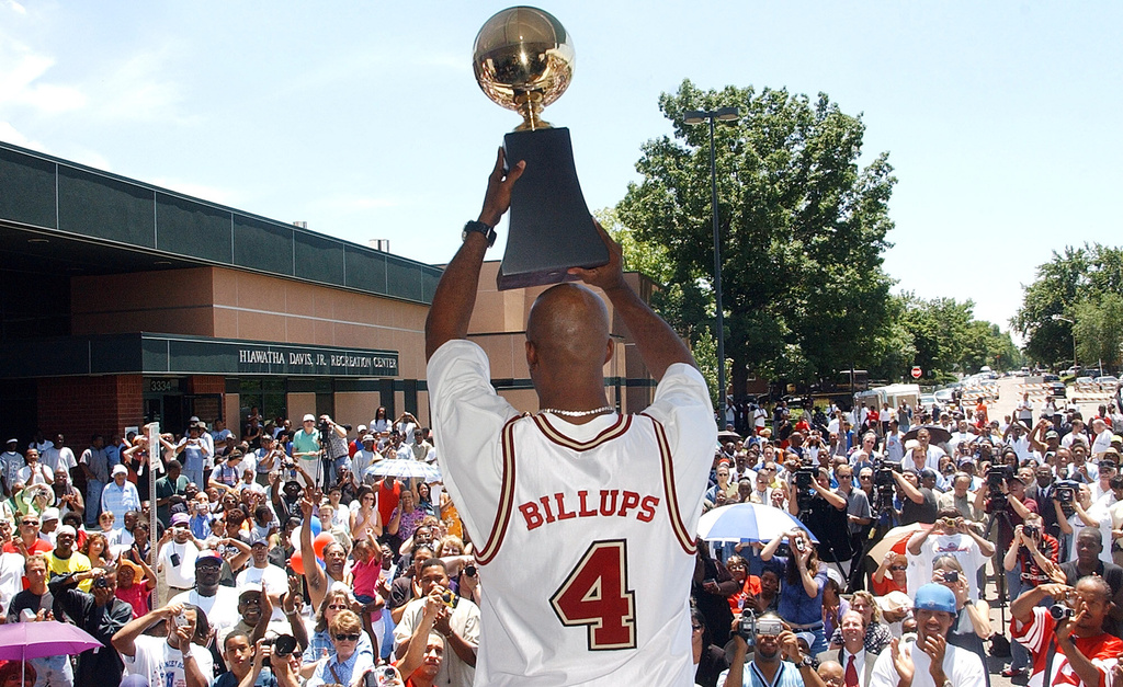 FILE - Denver native Chauncey Billups holds his MVP trophy for fans to see during a ceremony where he was honored in the Park Hill neighborhood of Denver on July 1, 2004. (AP Photo/Ed Andrieski, file)
