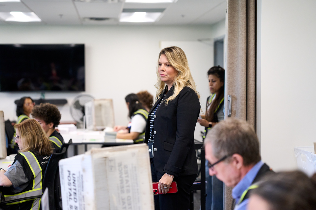 Olivia McCall, director of the Wake County Board of Elections, watches over employees preparing absentee ballots to be mailed on Thursday, Sept. 3, 2026, in Raleigh, N.C. (AP Photo/Matt Ramey)