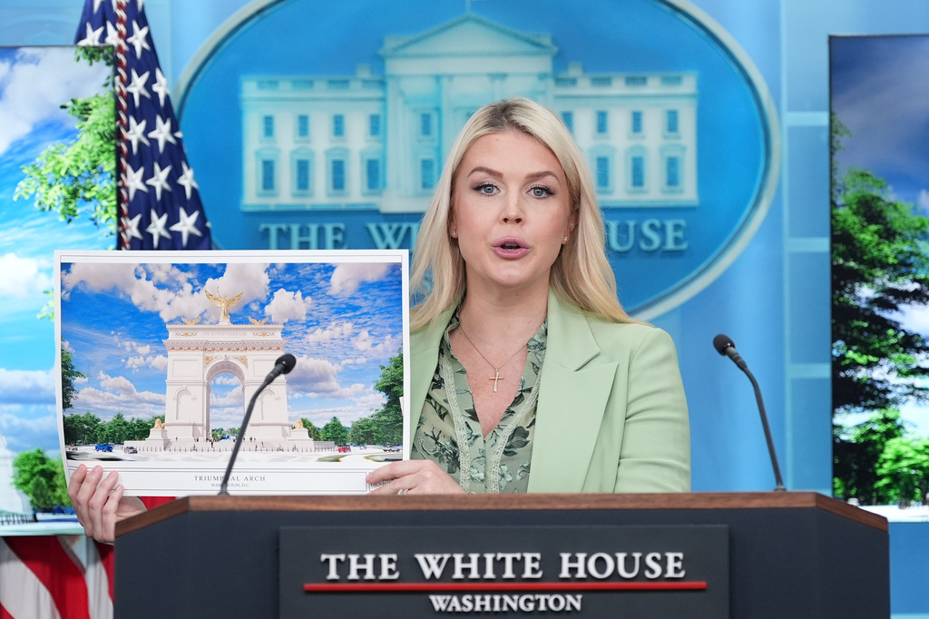 White House press secretary Karoline Leavitt holds up an artist rendering of the new triumphal arch as she speaks with reporters in the James Brady Press Briefing Room at the White House, Wednesday, April 15, 2026, in Washington. (AP Photo/Alex Brandon)