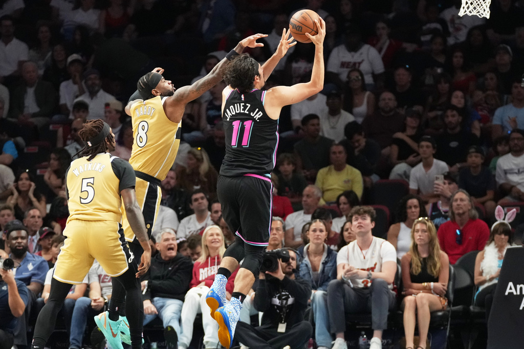 Miami Heat forward Jaime Jaquez Jr. (11) aims to score as Washington Wizards guard Jaden Hardy (8) defends during the first half of an NBA basketball game Saturday, April 4, 2026, in Miami. (AP Photo/Marta Lavandier)