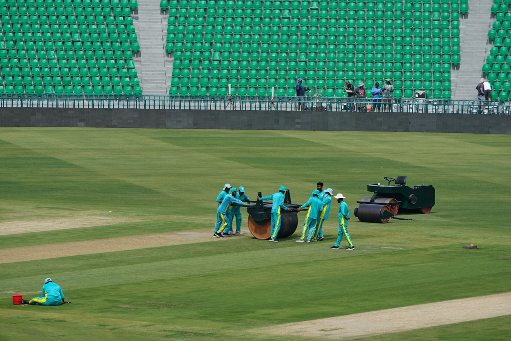Groundsmen work at the at the Gaddafi Stadium in preparations for upcoming Pakistan's premier domestic T20 the Pakistan Super League, which will take place in empty stadiums due to the recent spike in oil prices, in Lahore, Pakistan, Tuesday, March 24, 2026. (AP Photo/K.M. Chaudary)