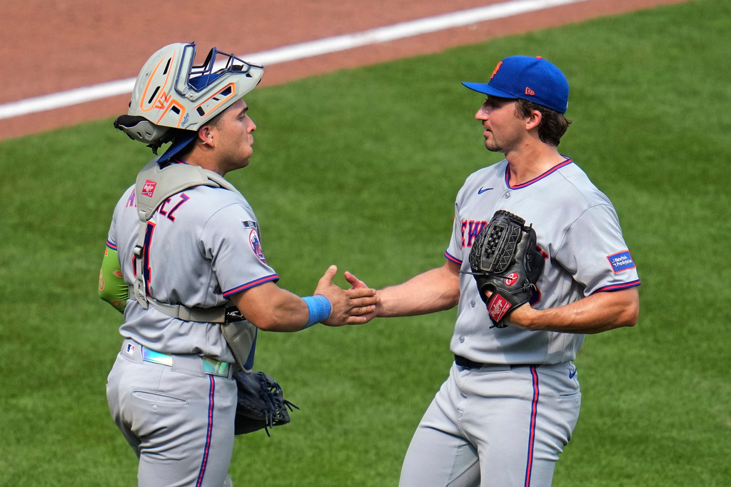 New York Mets pitcher Jack Weissenburger, right, celebrates with catcher Francisco Alvarez, left, after getting the final out of a baseball game against the Pittsburgh Pirates in Pittsburgh, Sunday, Aug. 9, 2026. (AP Photo/Gene J. Puskar)