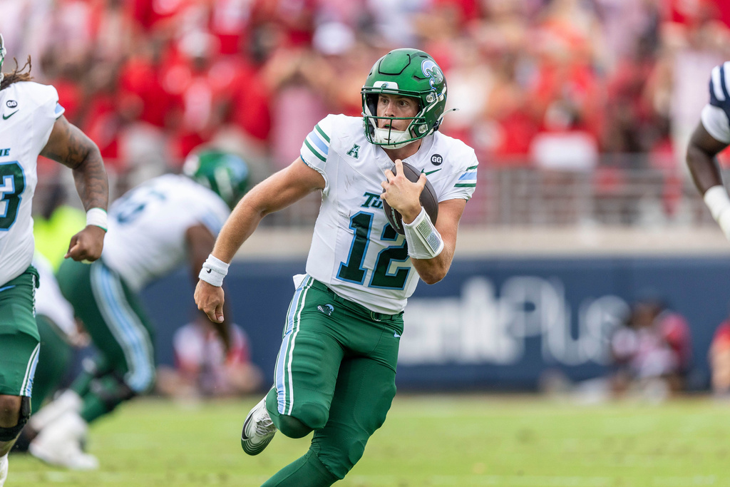 FILE - Tulane quarterback Jake Retzlaff (12) runs the ball against Mississippi during the first half of an NCAA football game on Saturday, Sept. 20, 2025, in Oxford, Miss. (AP Photo/Vasha Hunt, File)