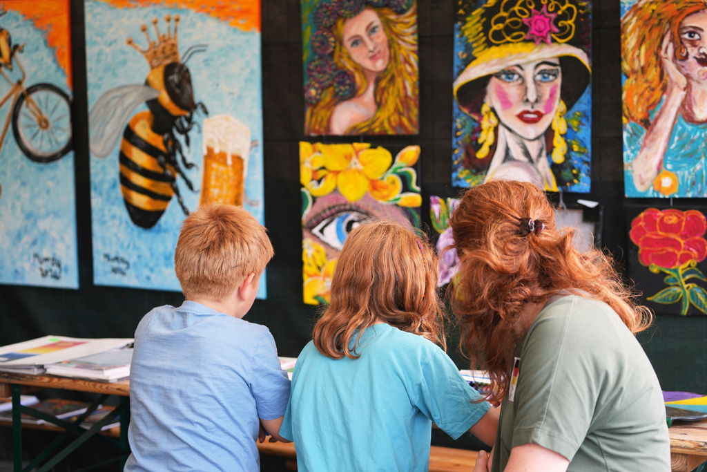 A family participate in a painting workshop during the Red Head Days festival in Tilburg, Netherlands, Saturday, Aug. 30, 2025. (AP Photo/Virginia Mayo)