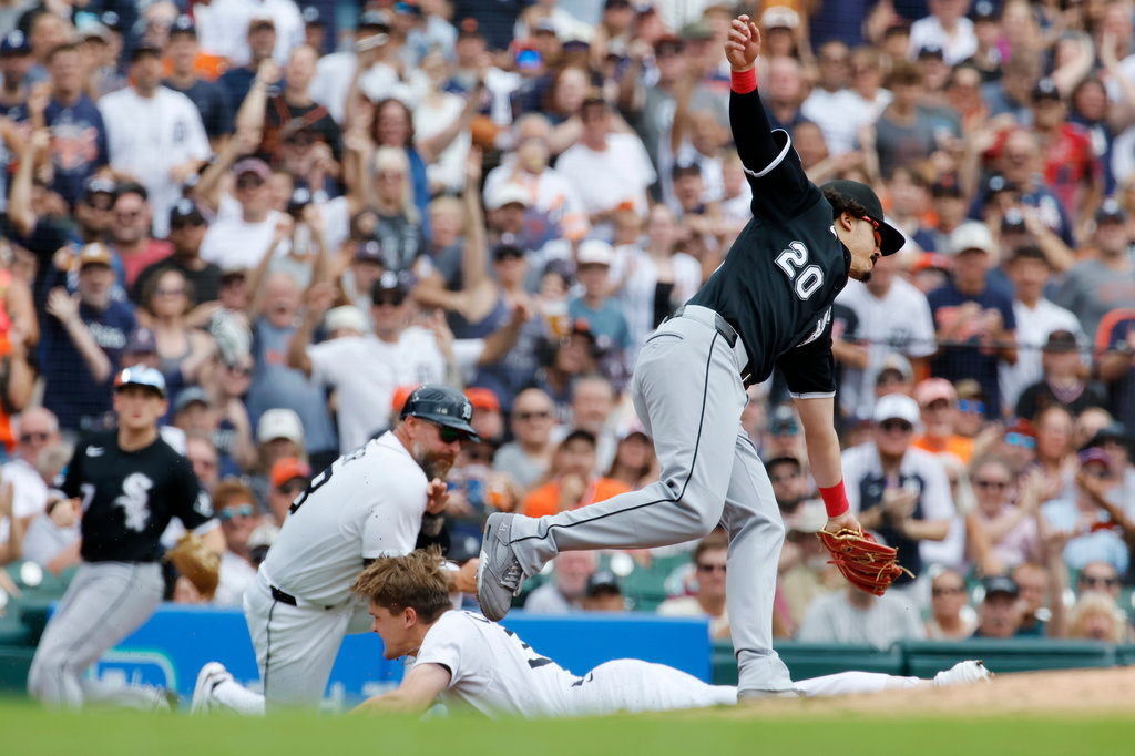 Chicago White Sox third baseman Miguel Vargas (20) fails to reach Detroit Tigers' Brett Callahan to make the tag, as Callahan slides into third base with a triple during the second inning of a baseball game Sunday, Aug. 16, 2026, in Detroit. (AP Photo/Duane Burleson)