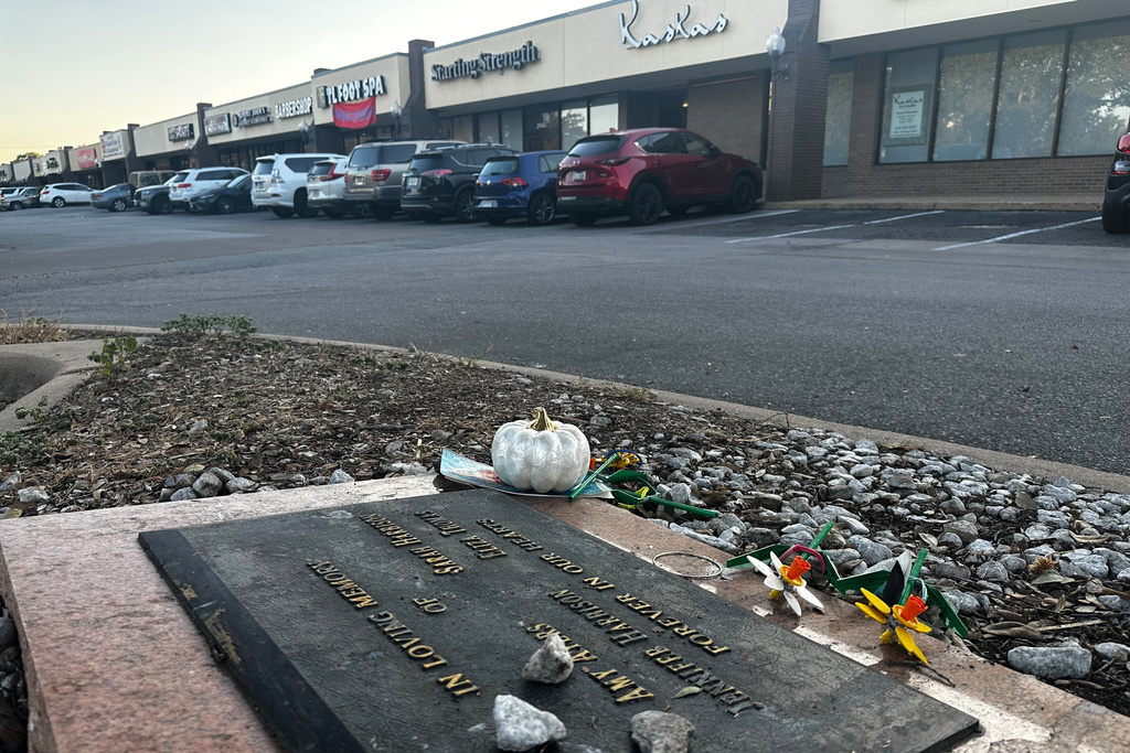 Tributes lay on a memorial Friday, Sept. 26, 2025, for four teenage girls who were killed in a yogurt shop in 1991 in Austin, Texas. (AP Photo/Paul J. Weber)