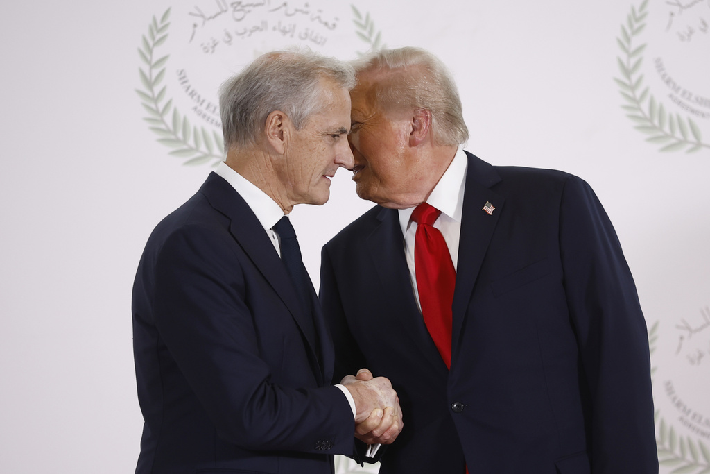 FILE - President Donald Trump and Norway's Prime Minister Jonas Gahr Store shake hands during the group photo at the Gaza International Peace Summit in Sharm el-Sheikh, Egypt, Oct.13 2025. (Yoan Valat, Pool photo via AP, File)