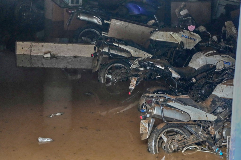 Damaged police bikes are parked in a flooded underground parking of a police station in Nea Makri, east of Athens, on Thursday, April 2, 2026, after heavy overnight storms caused extensive damage and left one person dead. (AP Photo/Thanassis Stavrakis)