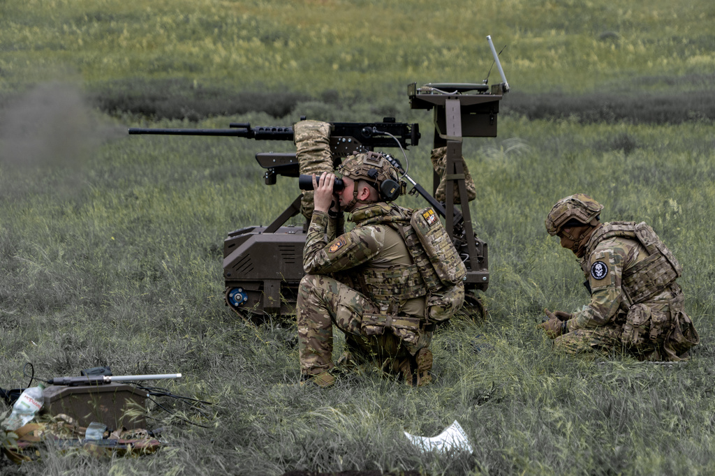 Ukrainian servicemen of the Cerberus Ground Unmanned Systems Company of the 60th Separate Mechanized Brigade, Third Army Corps, conduct a drill with a combat ground drone during a training at the polygon in Kharkiv region, Ukraine, Sunday, May 24, 2026. (AP Photo/Andrii Marienko)