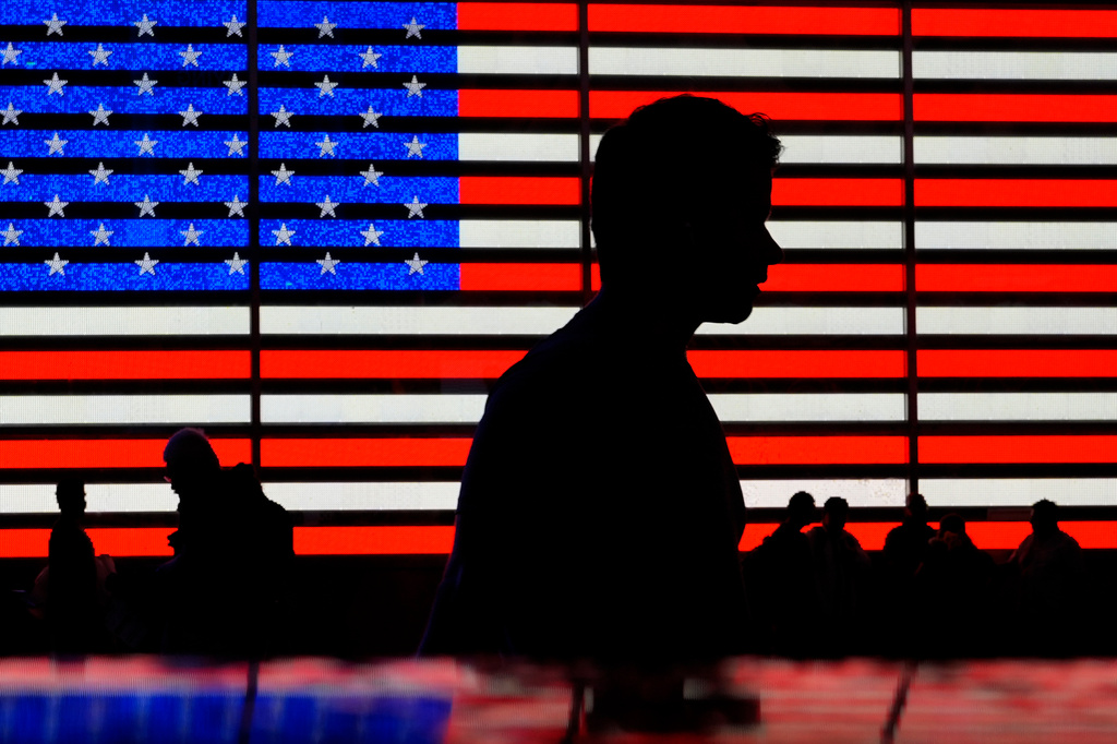 FILE - People stand in Times Square in New York, Friday, Aug. 9, 2024. (AP Photo/Pamela Smith, File)
