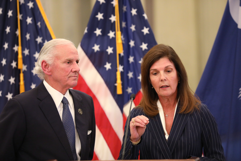 South Carolina Gov. Henry McMaster, left, listens as Lt. Gov. Pamela Evette, right, speaks at a news conference on Monday, Jan. 12, 2026, in Columbia, S.C. (AP Photo/Jeffrey Collins)