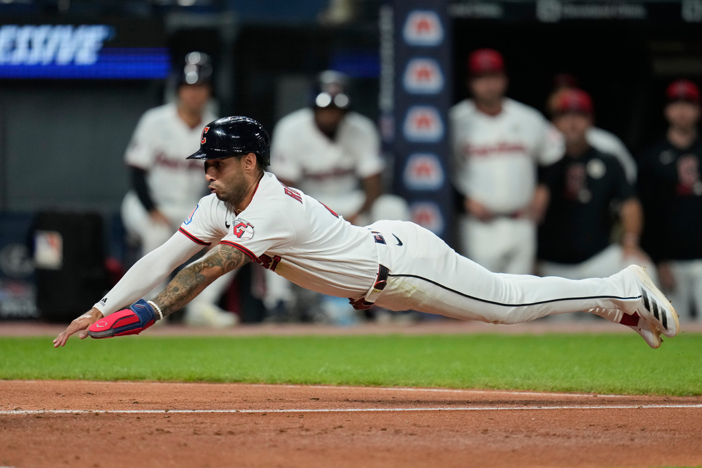 Cleveland Guardians' Brayan Rocchio dives for home plate in the fifth inning of a baseball game against the Chicago White Sox in Cleveland, Tuesday, Sept. 15, 2026. (AP Photo/Sue Ogrocki)