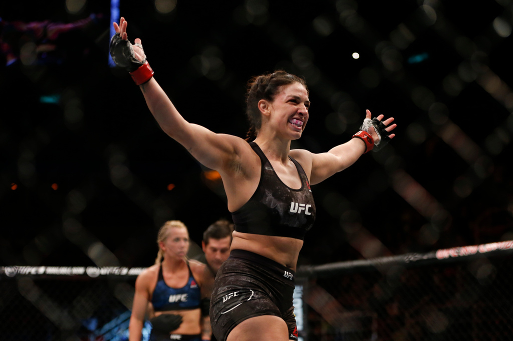 FILE - Mackenzie Dern, from the United States, celebrates after defeating countrywoman Amanda Cooper during their UFC women's strawweight mixed martial arts bout in Rio de Janeiro, Brazil, early Sunday, May 13, 2018. (AP Photo/Leo Correa, file)