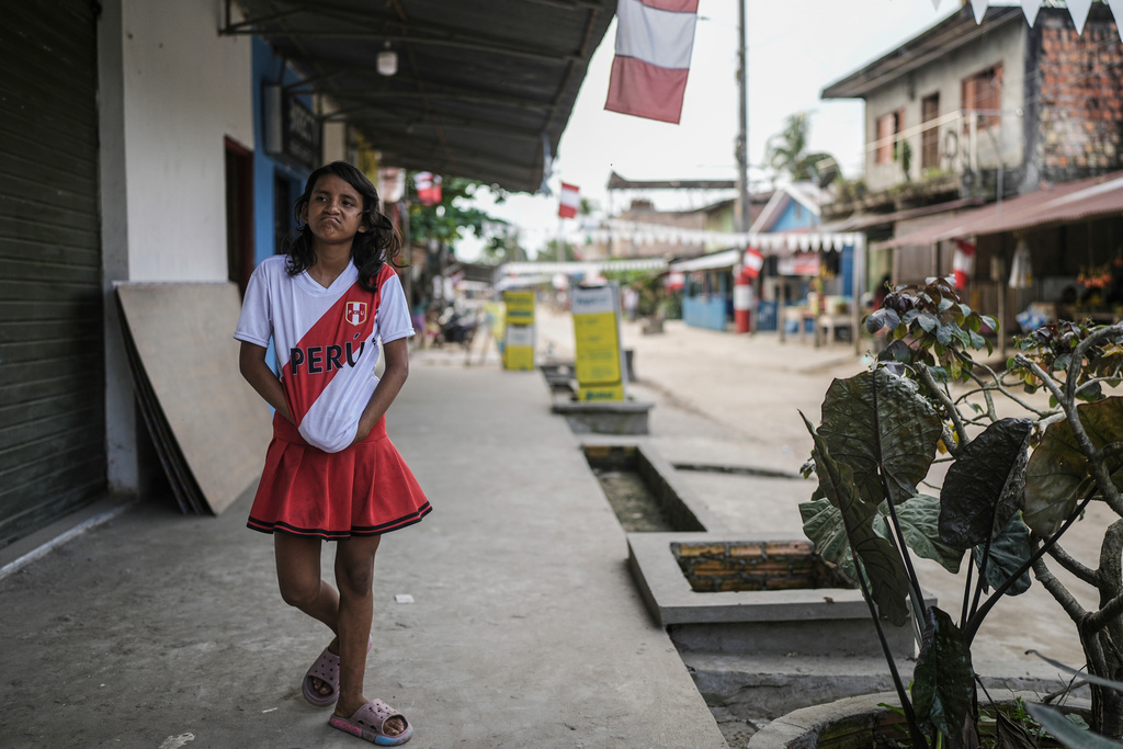 A girl walks along a street in Santa Rosa, Peru, an island on the Amazon River on the border with Colombia, Sunday, Aug. 17, 2025. (AP Photo/Ivan Valencia)
