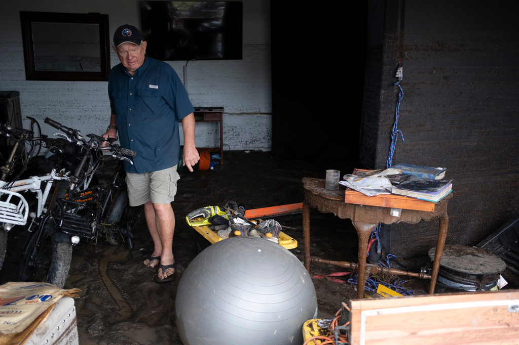 Bob Bettes assesses damage to his belongings after flooding reached the Buckhorn Lake Resort RV Park along West Goat Creek near the Guadalupe River on Friday, July 17, 2026, in Kerrville, Texas. (AP Photo/Joel Angel Juarez)