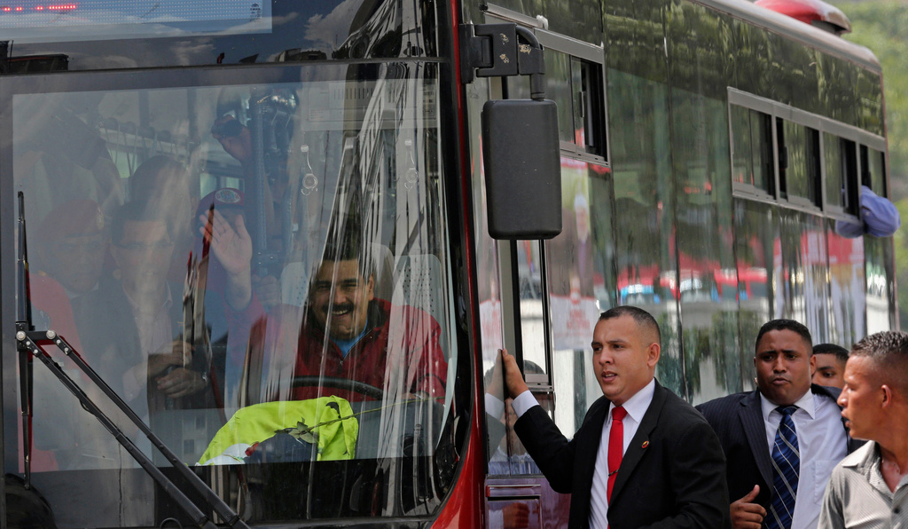 FILE - Venezuela's President Nicolas Maduro arrives at the Miraflores Palace, driving a bus from the airport after returning home from a two-week fundraising trip, in Caracas, Venezuela, Jan. 17, 2015. (AP Photo/Ariana Cubillos, File)