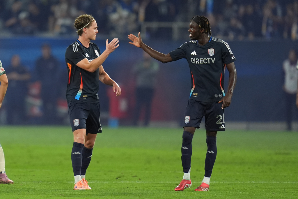 San Diego FC midfielder Onni Valakari, left, celebrates his goal with teammate midfielder Manu Duah, right, during the first half of Game 1 in the first round of MLS soccer's Western Conference playoff against Portland Timbers Sunday, Oct. 26, 2025, in San Diego. (AP Photo/Gregory Bull)