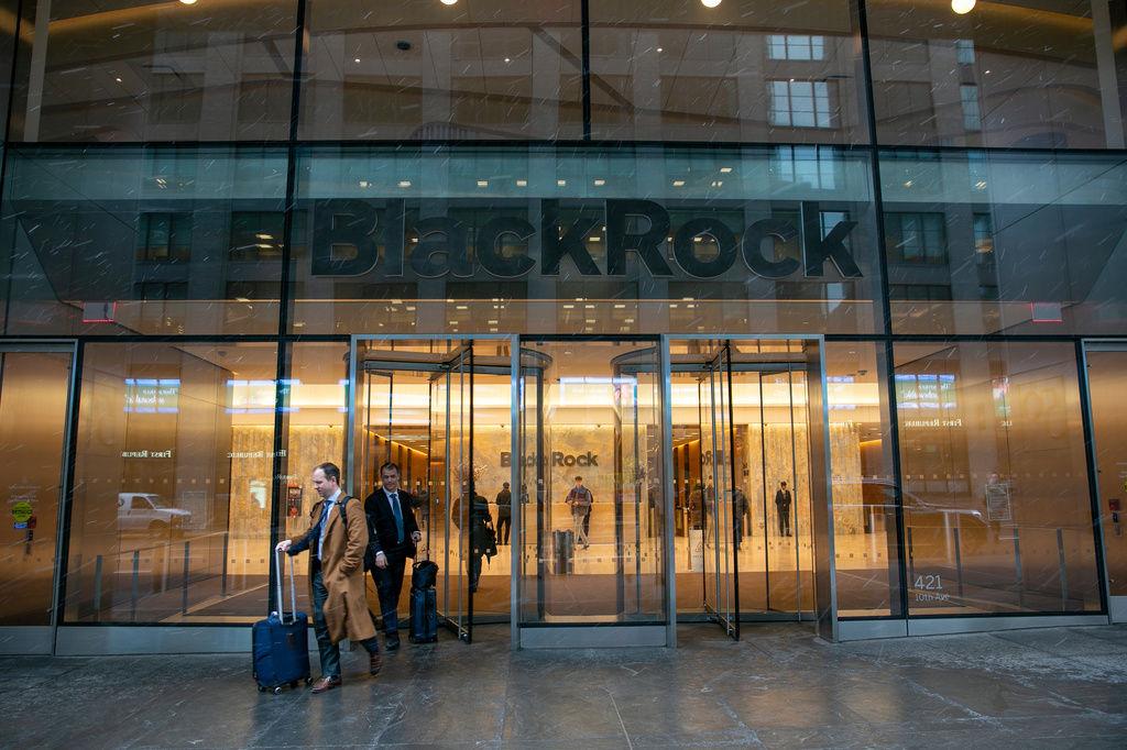 FILE - People leave the The BlackRock investment company in the Hudson Yards neighborhood of New York, Tuesday, March 14, 2023. (AP Photo/Ted Shaffrey, File)