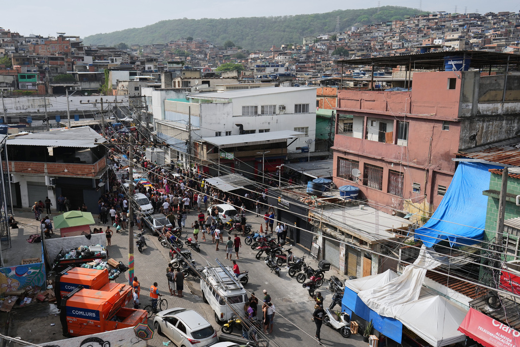 Residents surround the bodies of people killed the day before during a police raid targeting the Comando Vermelho gang in the Complexo da Penha favela of Rio de Janeiro, Brazil, Wednesday, Oct. 29, 2025. (AP Photo/Silvia Izquierdo)