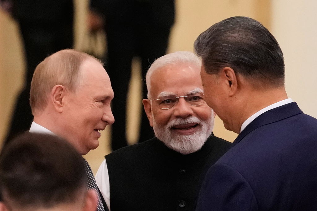 Russian President Vladimir Putin, from left, Indian Prime Minister Narendra Modi and Chinese President Xi Jinping talk ahead of the Shanghai Cooperation Organization (SCO) summit at the Meijiang Convention and Exhibition Center in Tianjin, China, Monday, Sept. 1, 2025. (Suo Takekuma/Pool Photo via AP)