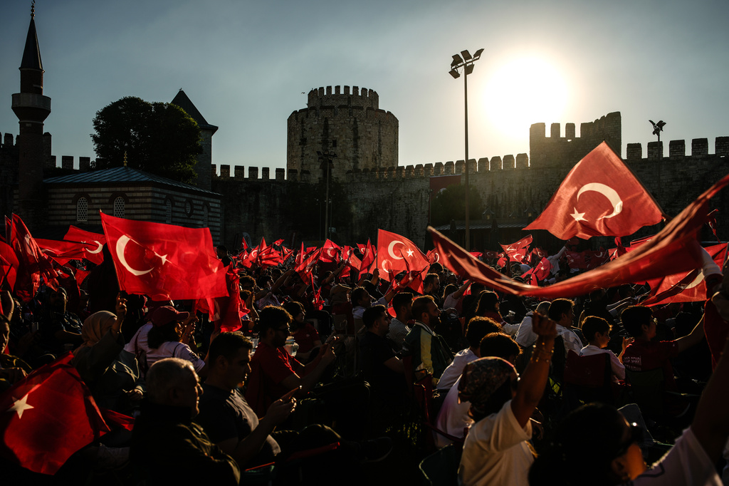 People gather to watch live in a giant screen the World Cup Group D soccer match between Australia and Turkey, at the historic Yedikule fortress in Istanbul, Turkey, Sunday, June 14, 2026. (AP Photo/Emrah Gurel)