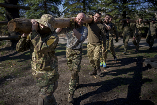 Recruits of the 3rd Assault Brigade train in the Kyiv region, Ukraine, Tuesday, April 9, 2024. (AP Photo/Vadim Ghirda)