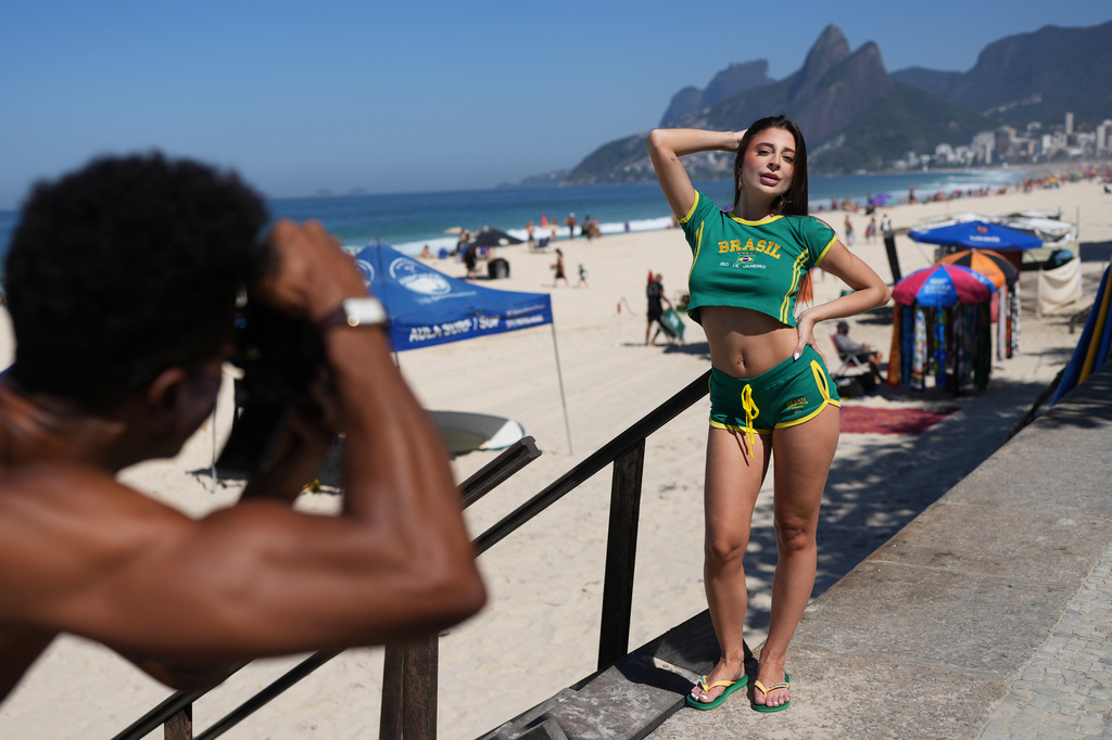 Influencer Gabriela Catao poses for photos at Ipanema beach in Rio de Janeiro, on Sept. 4, 2026. (AP Photo/Silvia Izquierdo)