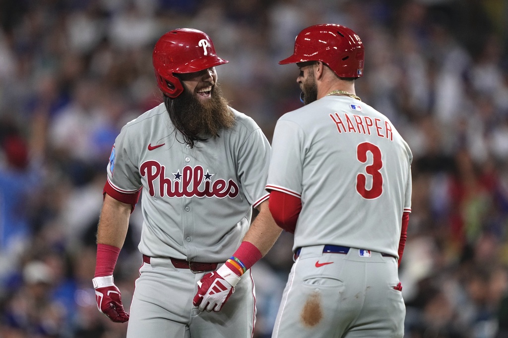 Philadelphia Phillies' Brandon Marsh, left, is congratulated by Bryce Harper after hitting a three-run home run during the sixth inning of a baseball game against the Los Angeles Dodgers, Tuesday, Sept. 16, 2025, in Los Angeles. (AP Photo/Mark J. Terrill)