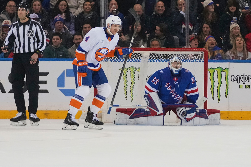 New York Islanders' Carson Soucy (4) skartes past New York Rangers goaltender Jonathan Quick (32) after scoring a goal during the second period of an NHL hockey game Thursday, Jan. 29, 2026, in New York. (AP Photo/Frank Franklin II)