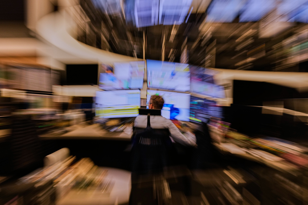 A broker watches his screens at the stock market in Frankfurt, Germany, Monday, March 9, 2026. (AP Photo/Michael Probst)