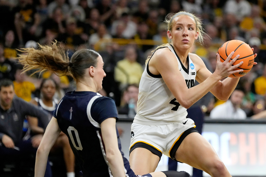 Iowa guard Kylie Feuerbach (4) is fouled by Fairleigh Dickinson guard Madlena Gerke (0) during the first half in the first round of the NCAA college basketball tournament, Saturday, March 21, 2026, in Iowa City, Iowa. (AP Photo/Charlie Neibergall)