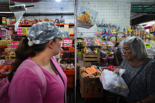 Women walk past stalls where sugar skulls known as “calaveritas” or little skulls, traditionally added to Day of the Dead altars honoring deceased loved ones, are displayed for sale at the Dulces de Ampudia market in Mexico City, Thursday, Oct. 30, 2025. (AP Photo/Claudia Rosel) Women walk past stalls where sugar skulls known as “calaveritas” or little skulls, traditionally added to Day of the Dead altars honoring deceased loved ones, are displayed for sale at the Dulces de Ampudia market in Mexico City, Thursday, Oct. 30, 2025. (AP Photo/Claudia Rosel)