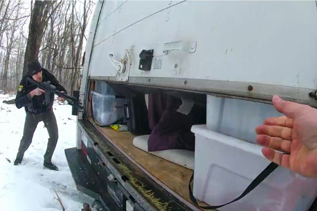 This image taken from a Maryland State Police body cam video and released in a court filing shows an officer pointing a rifle at a partially-open a box truck, Feb. 16, 2025, in Frostburg, Md. (Maryland State Police via AP)