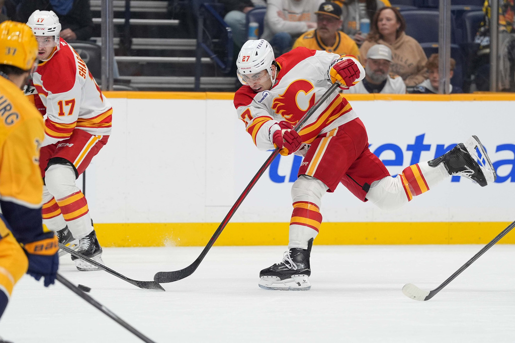 Calgary Flames right wing Matt Coronato (27) shoots the puck during the first period of an NHL hockey game against the Nashville Predators, Saturday, Nov. 1, 2025, in Nashville, Tenn. (AP Photo/Camden Hall)