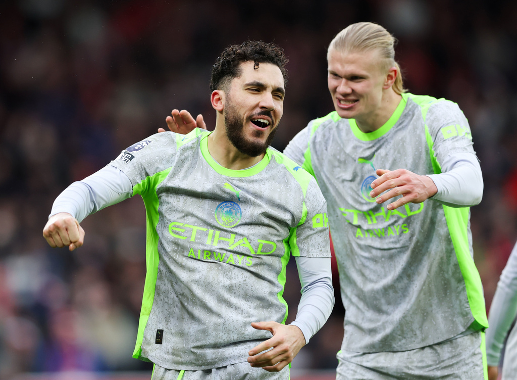 Manchester City's Rayan Cherki, left, celebrates with Erling Haaland after scoring his side's second goal during the Premier League match between Nottingham Forest and Manchester City, in Nottingham, England, Saturday Dec. 27, 2025. (Barrington Coombs/PA via AP)
