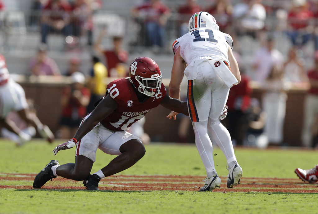 Oklahoma linebacker Kip Lewis (10) stops Auburn quarterback Jackson Arnold (11) during a play in the first half of an NCAA college football game Saturday, Sept. 20, 2025, in Norman, Okla. (AP Photo/Alonzo Adams)