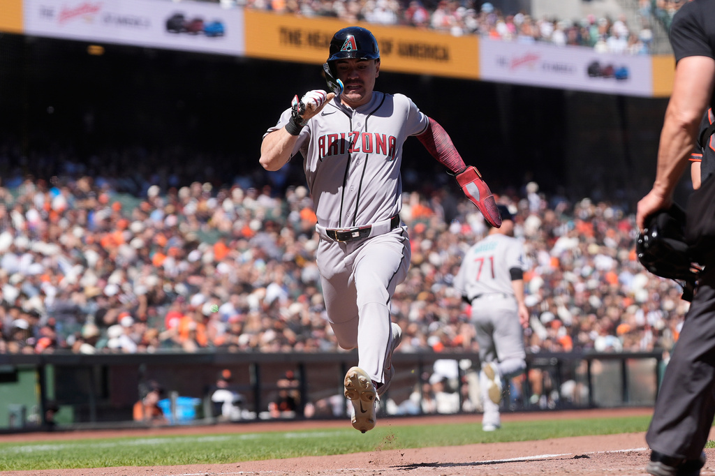 Arizona Diamondbacks' Corbin Carroll runs home to score against the San Francisco Giants during the eighth inning of the first baseball game of a doubleheader, Saturday, Aug. 29, 2026, in San Francisco. (AP Photo/Jeff Chiu)