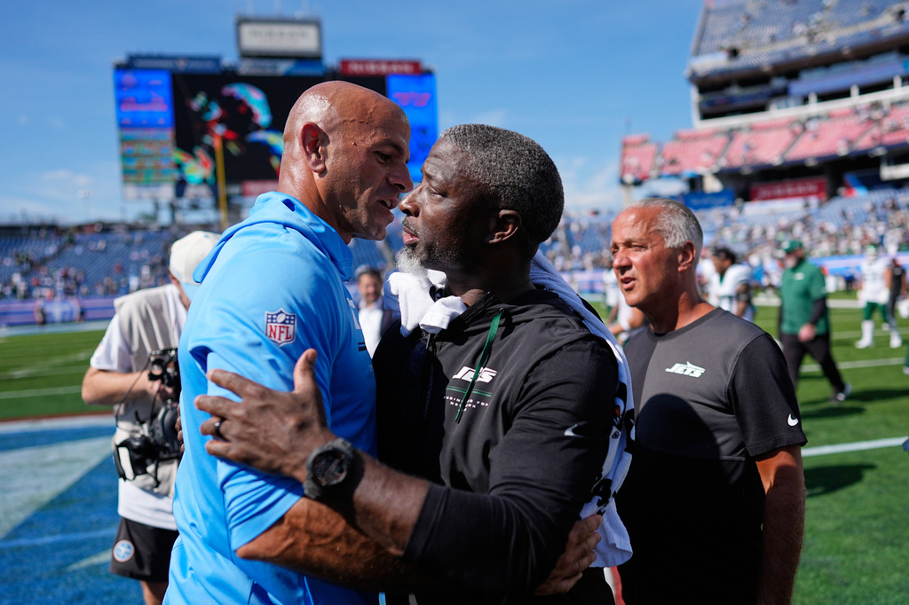 Tennessee Titans head coach Robert Saleh, left, hugs New York Jets head coach Aaron Glenn at the end of an NFL football game, Sunday, Sept. 13, 2026, in Nashville, Tenn. (AP Photo/George Walker IV)