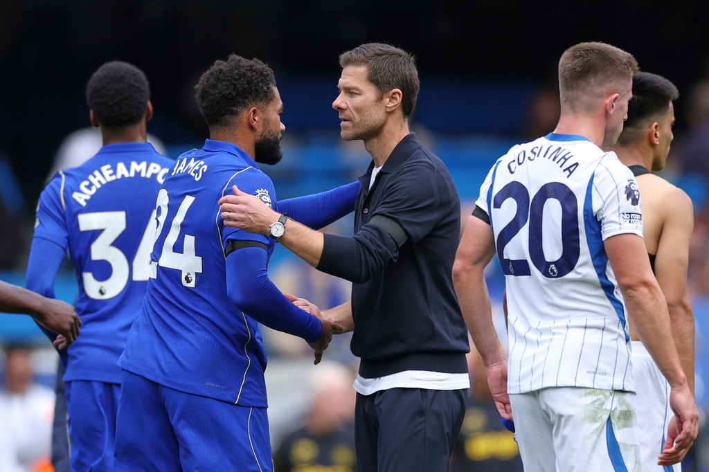 Chelsea's head coach Xabi Alonso greets Chelsea's Reece James after the English Premier League soccer match between Chelsea and Brighton and Hove Albion in London, Sunday, Aug. 30, 2026. (AP Photo/Ian Walton)