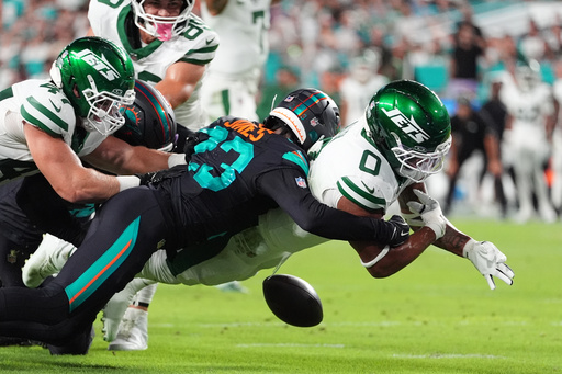 New York Jets running back Braelon Allen (0) fumbles the ball after taking a hit from Miami Dolphins cornerback Jack Jones, rear, in the first half of an NFL football game, Monday, Sept. 29, 2025, in Miami Gardens, Fla. (AP Photo/Rebecca Blackwell) New York Jets running back Braelon Allen (0) fumbles the ball after taking a hit from Miami Dolphins cornerback Jack Jones, rear, in the first half of an NFL football game, Monday, Sept. 29, 2025, in Miami Gardens, Fla. (AP Photo/Rebecca Blackwell)