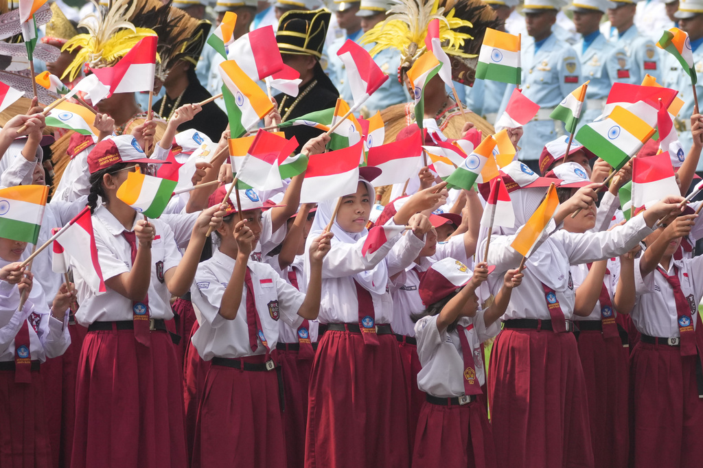 School children wave Indian and Indonesian national flags during the welcoming ceremony for India's Prime Minister Narendra ahead of his meeting with Indonesian President Prabowo Subianto at Merdeka Palace in Jakarta, Indonesia, Tuesday, July 7, 2026. (AP Photo/Achmad Ibrahim)