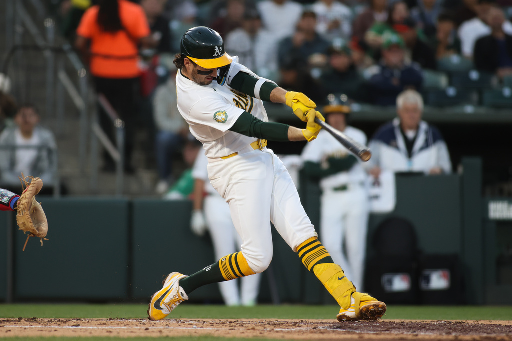 Athletics' Jacob Wilson hits an two RBI single during the third inning of a baseball game against the Texas Rangers, Tuesday, April 14, 2026, in West Sacramento, Calif. (AP Photo/Scott Marshall)