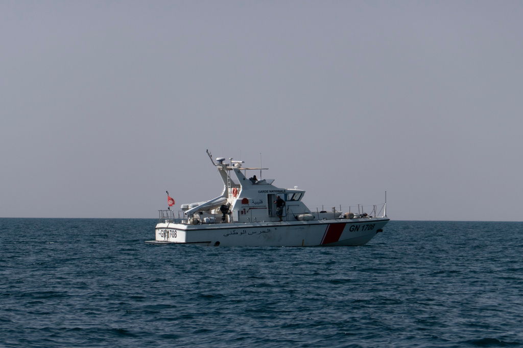 A Tunisian national guard boat conducts a search operation after a boat carrying migrants capsized off the country's southeastern coast, near Zarzis, Tunisia, Sunday, Aug. 23, 2026. (AP Photo/Bassem Aouini)