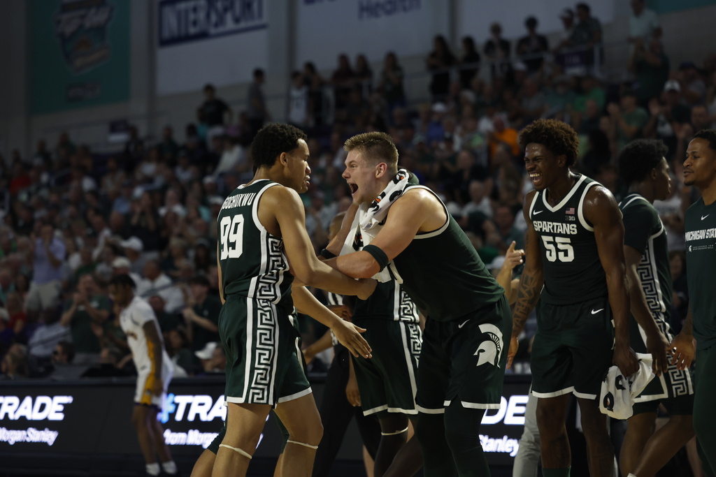 Michigan State forward Jaxon Kohler, center, celebrates with teammate guard Divine Ugochukwu against East Carolina during the first half of an NCAA college basketball game, Tuesday, Nov. 25, 2025 in Ft. Myers, Fla. (AP Photo/Scott Audette)